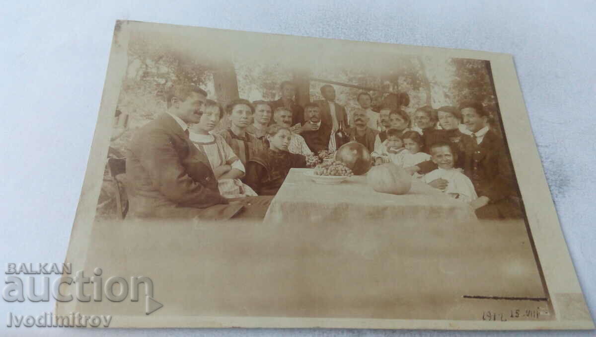 Fotografie Bărbați, femei și copii la o masă cu mâncare, 1912