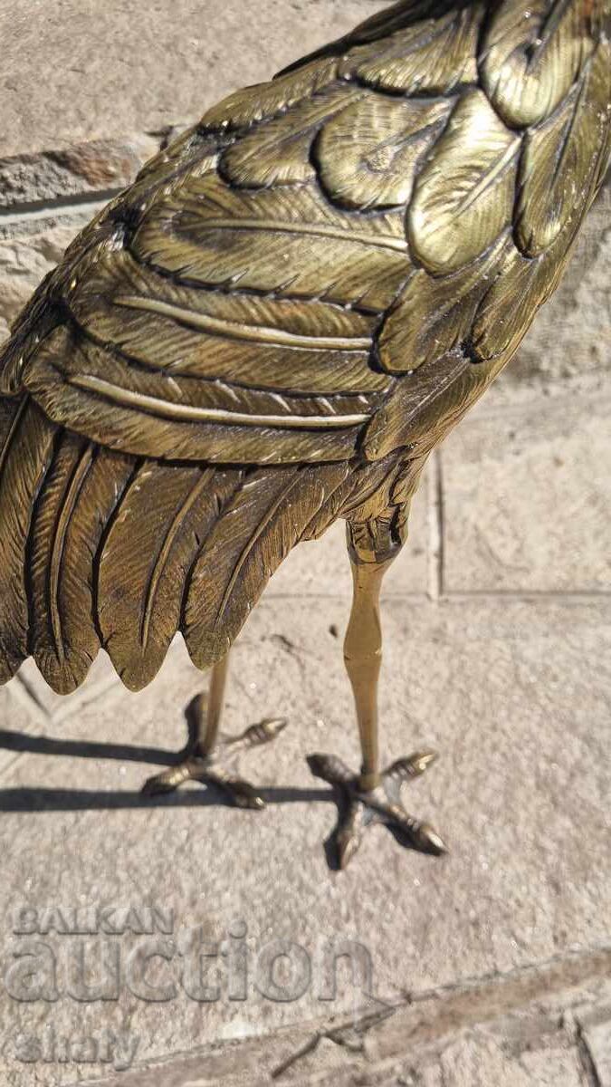 Delivery of Old bronze sculpture. Bronze heron figure