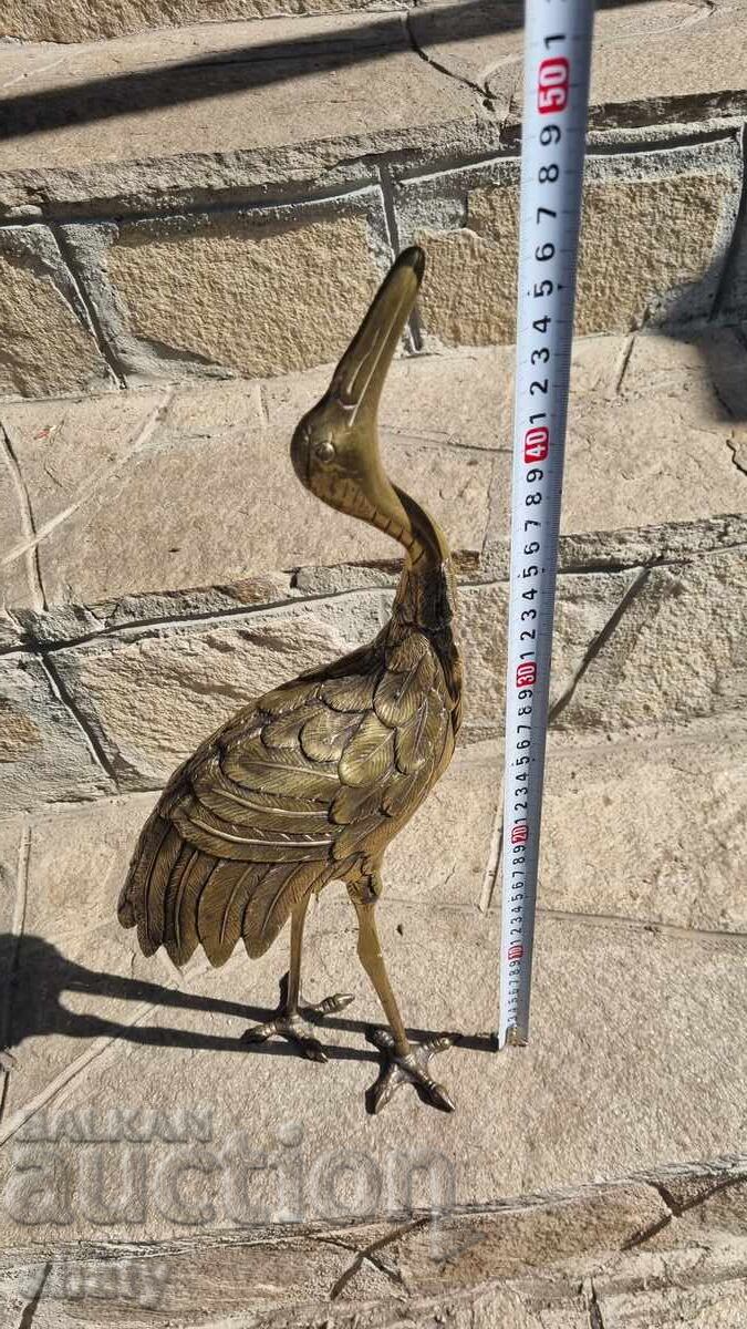 Old bronze sculpture. Bronze heron figure