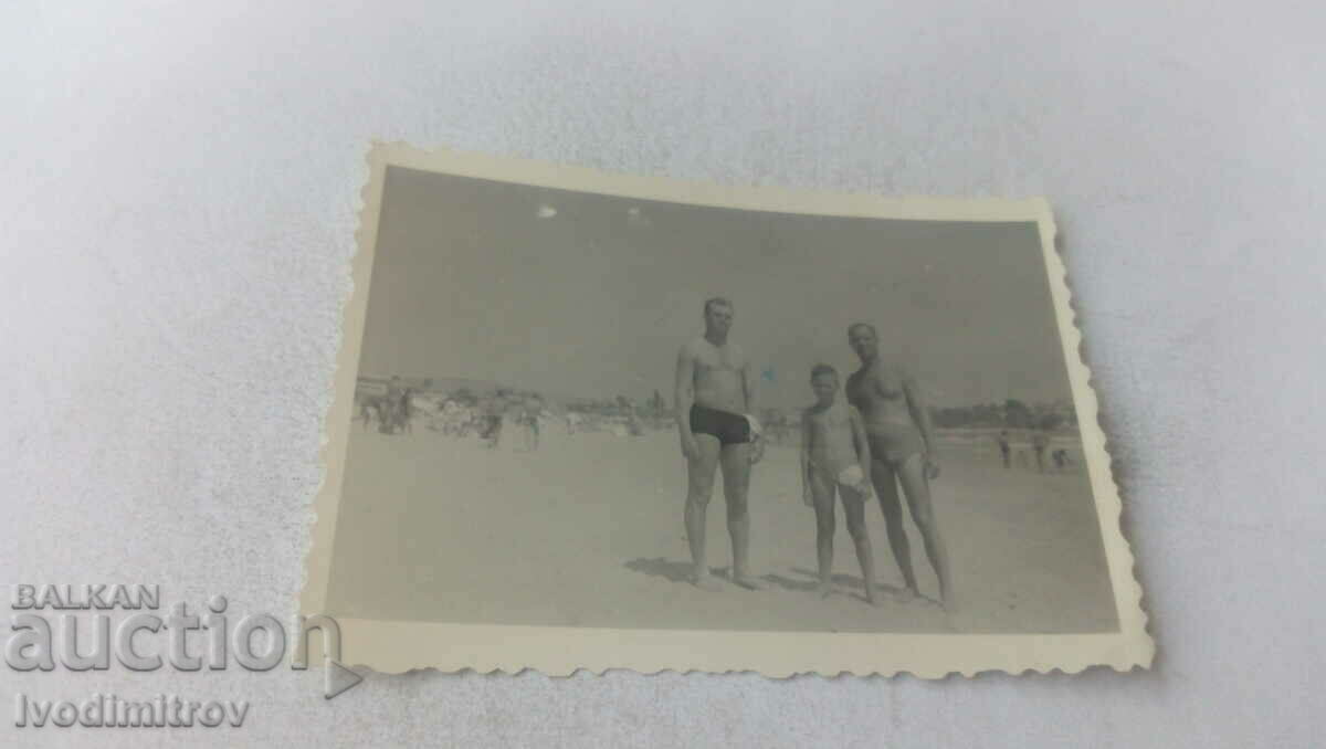 Picture Two men and a boy on the beach