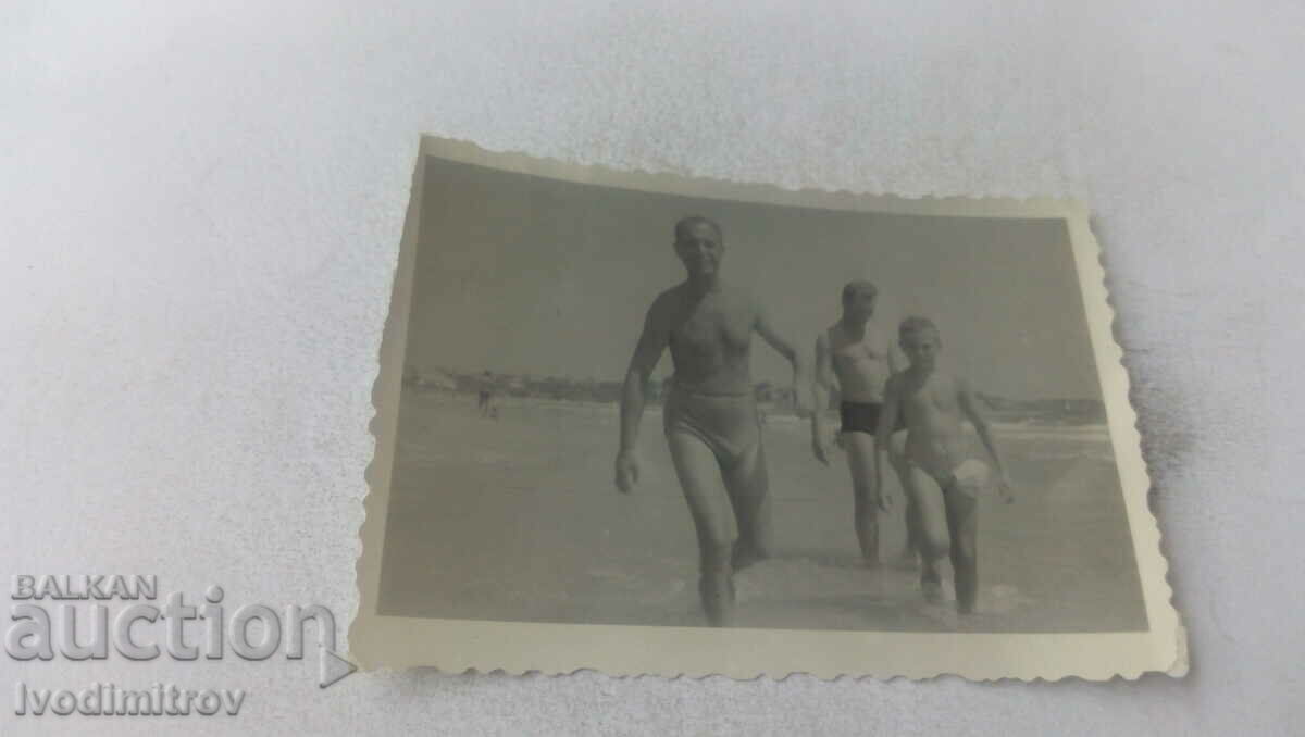 Photo Two men and a boy on the beach