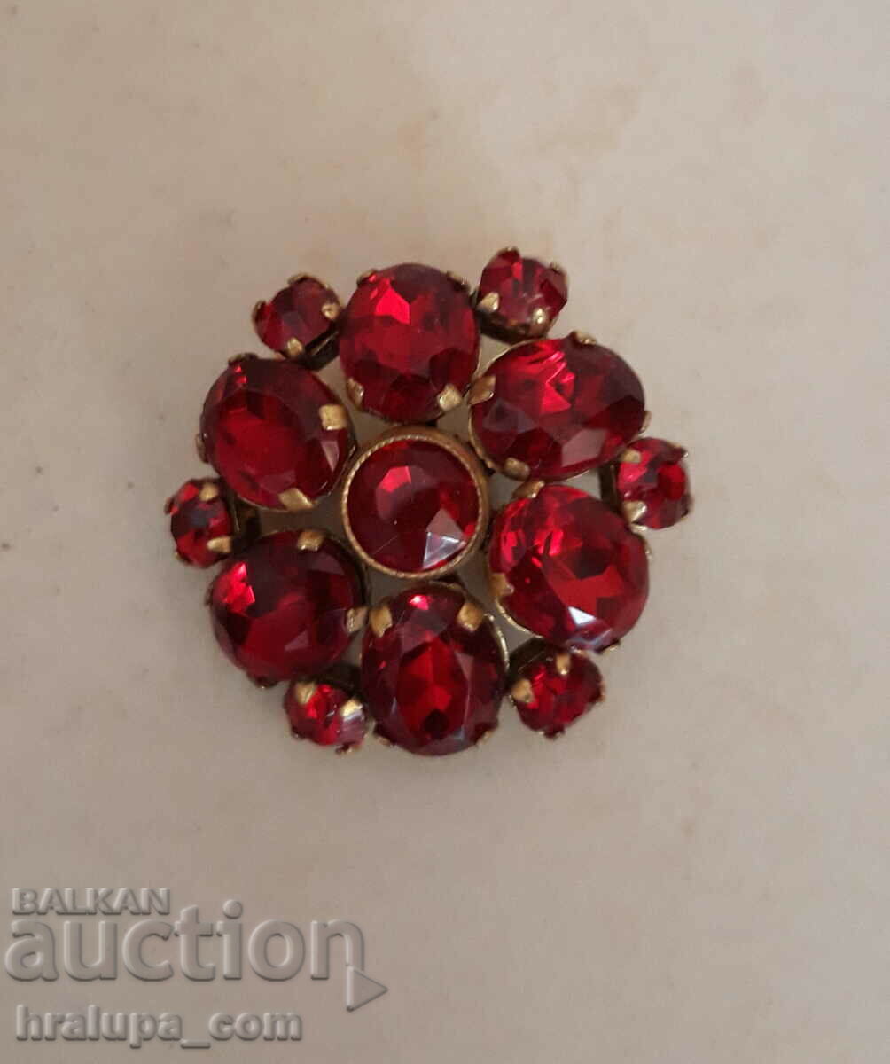 Old brooch with red crystals