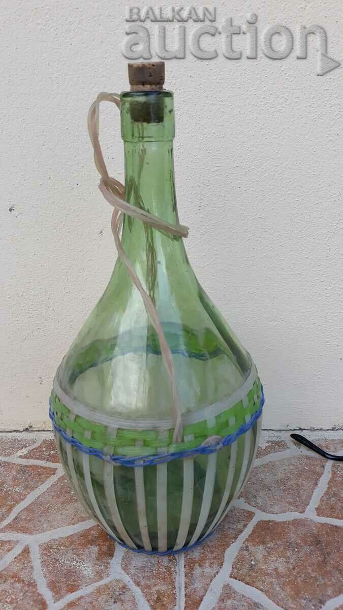 Delivery of old vintage retro damaged bottle with braid Delivery of old vintage retro damaged bottle with braid