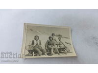 Photo Four foremen sitting on handcarts