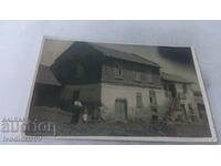 Photo A man and three girls in front of his house