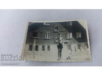 Photo A man in shorts in front of a mountain hut