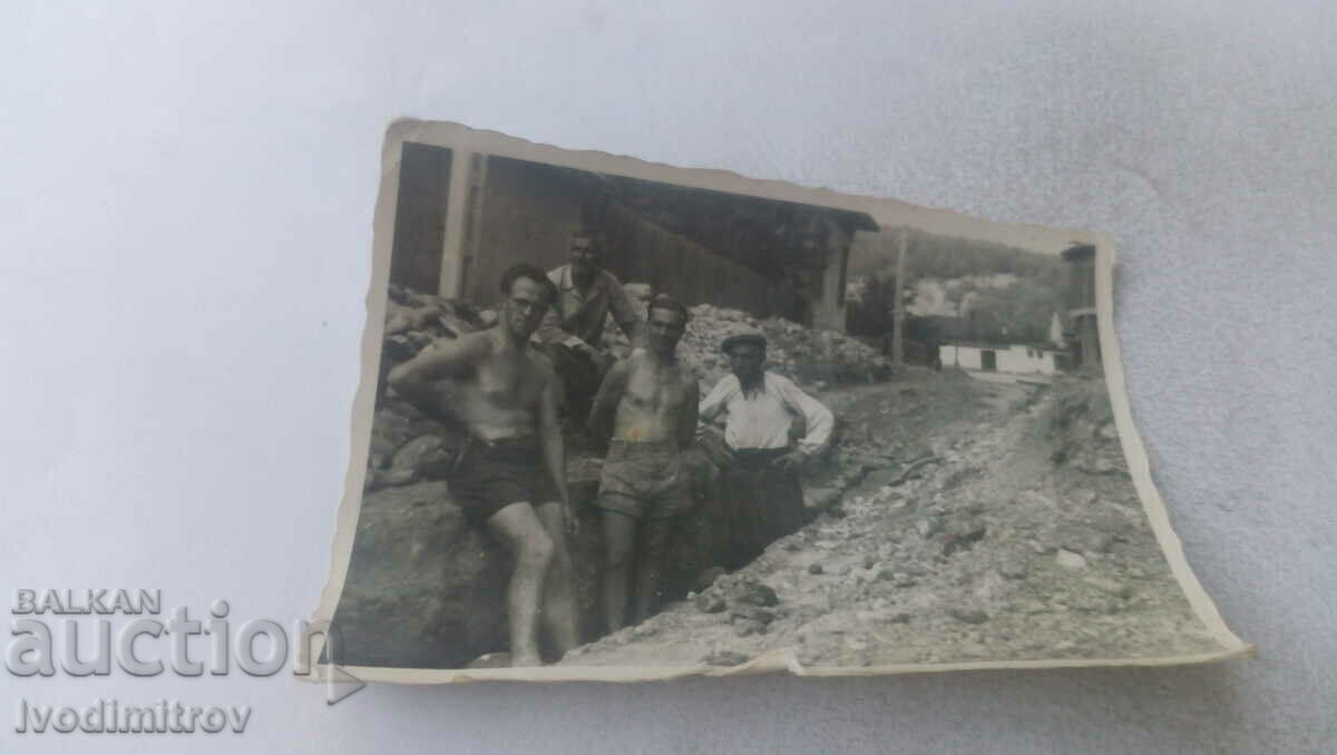 Photo Four men in a newly dug trench