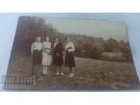 Photo A boy and three girls on the meadow