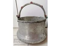 An old copper pot, a tin boiler, a baker, a spoon