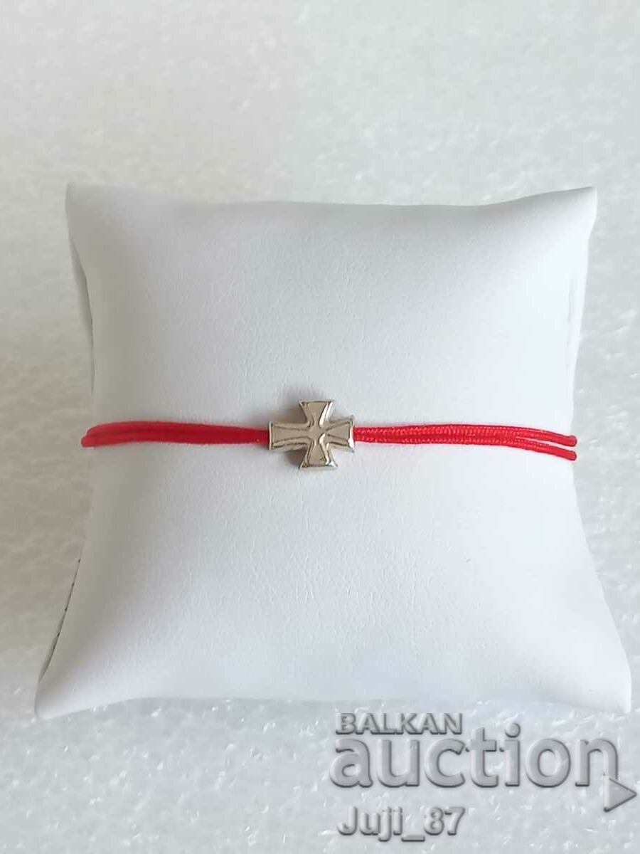 Silver bracelet with cross and red thread