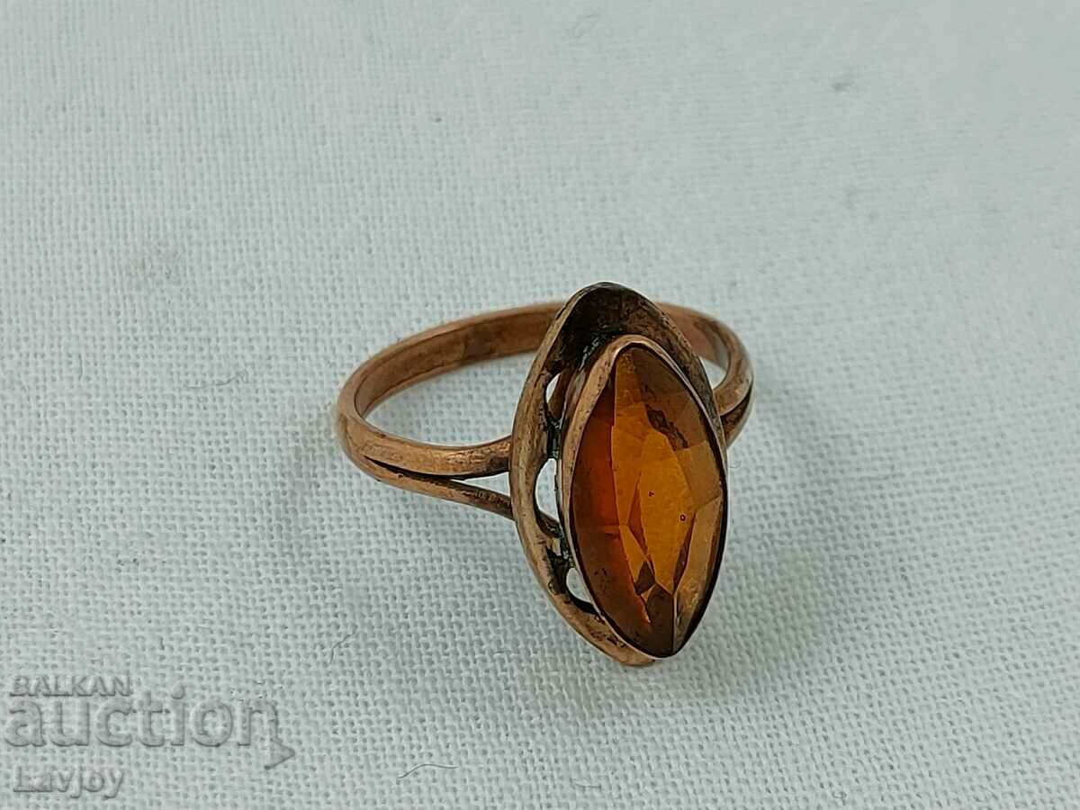 Old gold-plated ring with an amber-colored stone