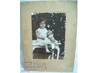 Fotografie veche a unui copil din carton cu o păpușă