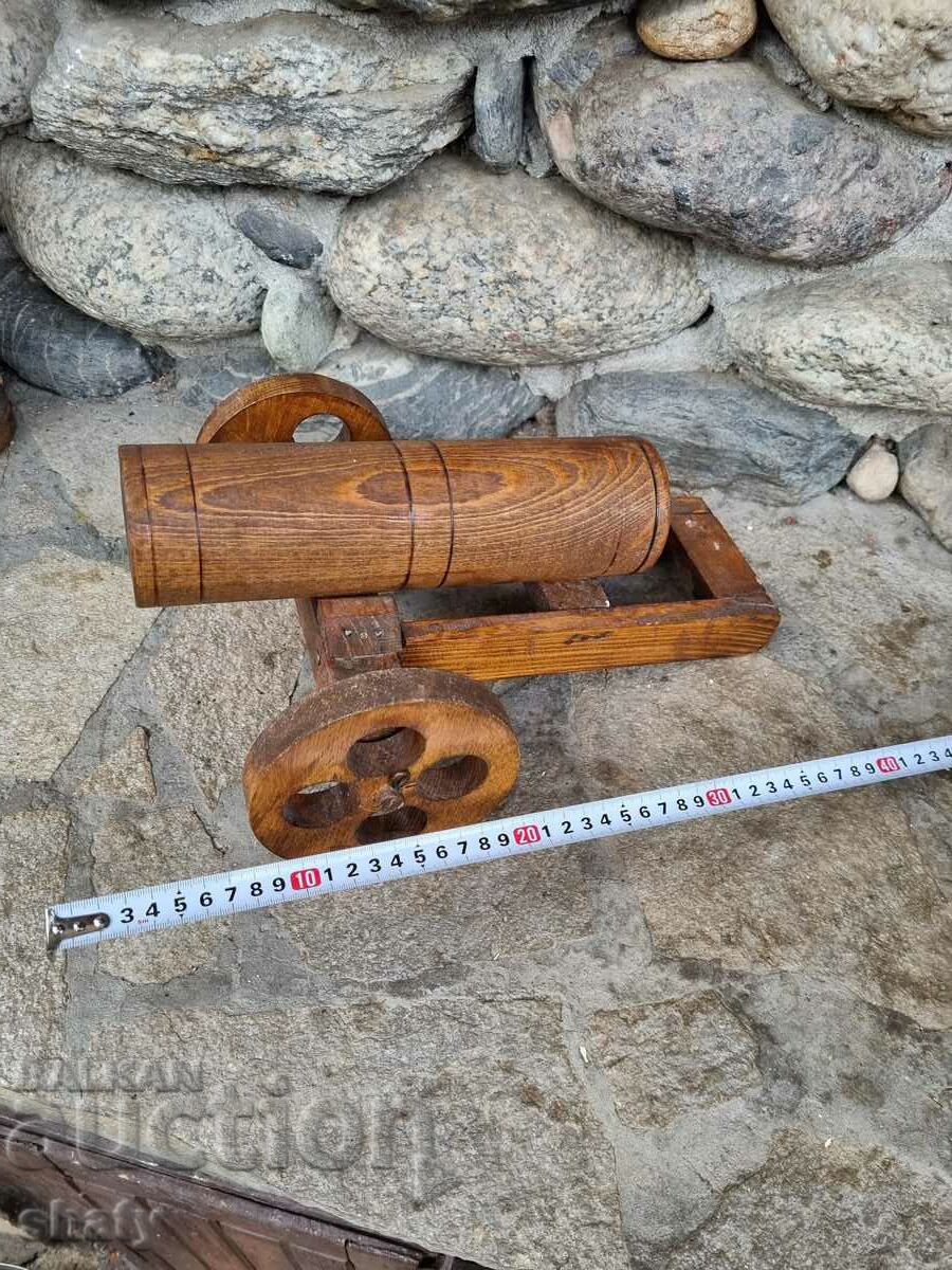 A large wooden cannon. The cherry ball