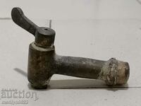 Old bronze crane, cannula faucet