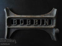 Cast iron emblem from an old sewing machine