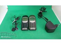 Two Nokia 6210 phones with one charger and headphones