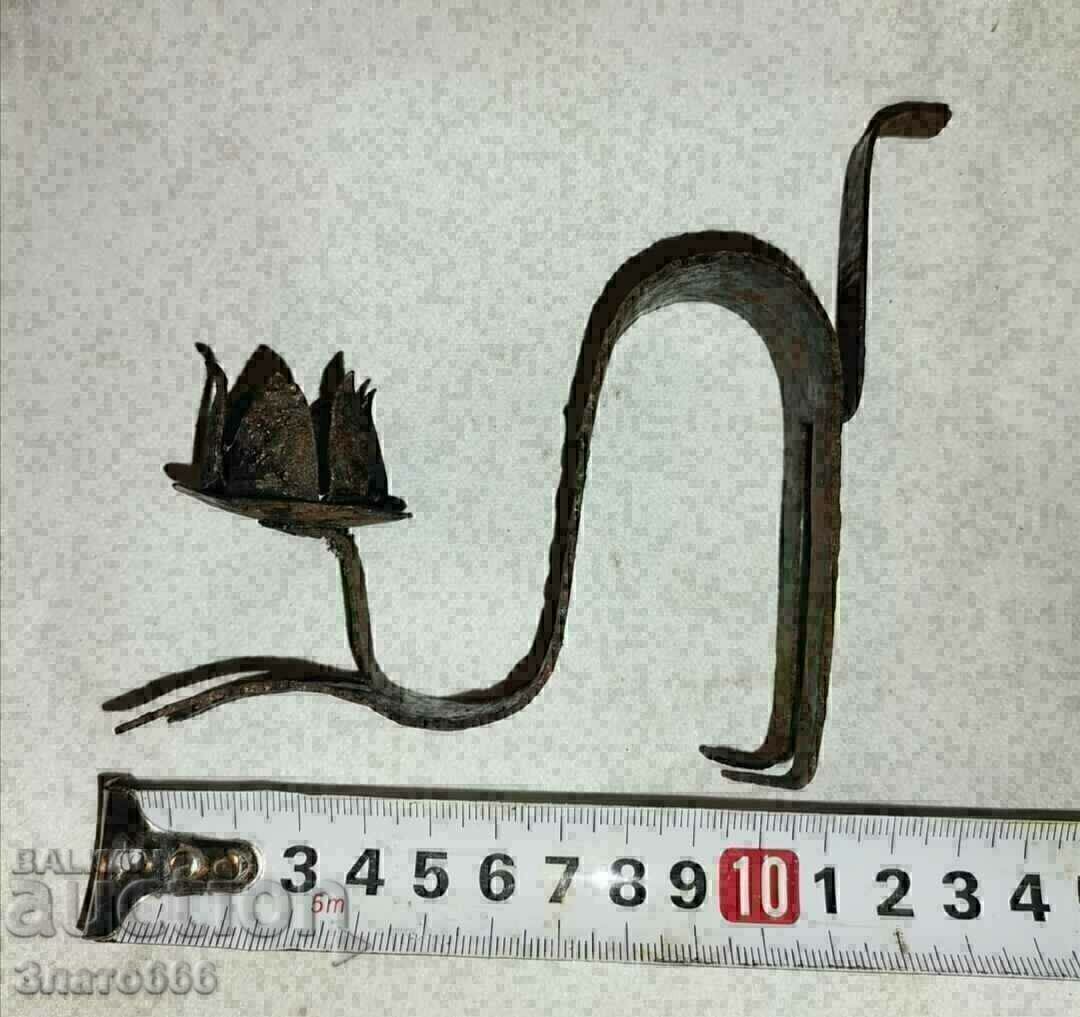 Old metal candlestick cat