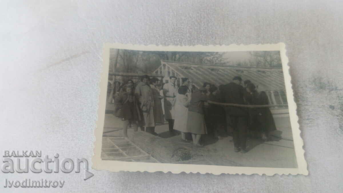Photo Men and women in front of a wooden building under construction