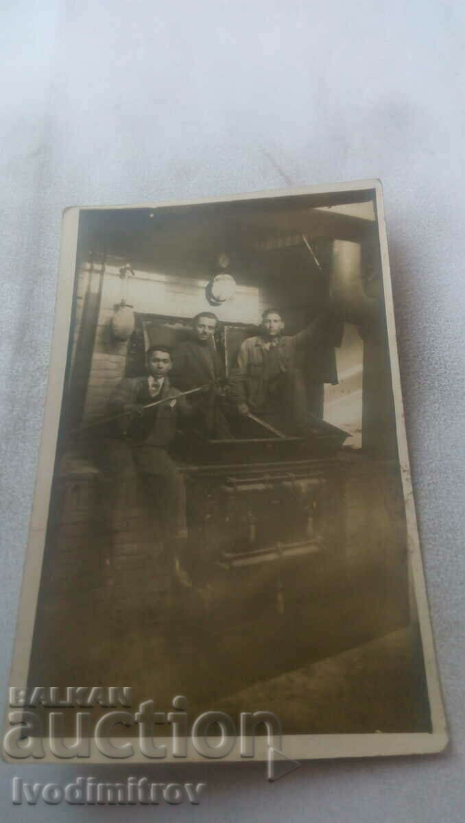 Photo Three men in front of a furnace