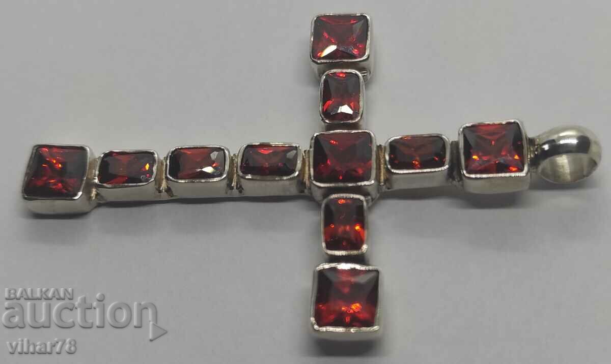 Delivery of A large silver cross studded with garnets