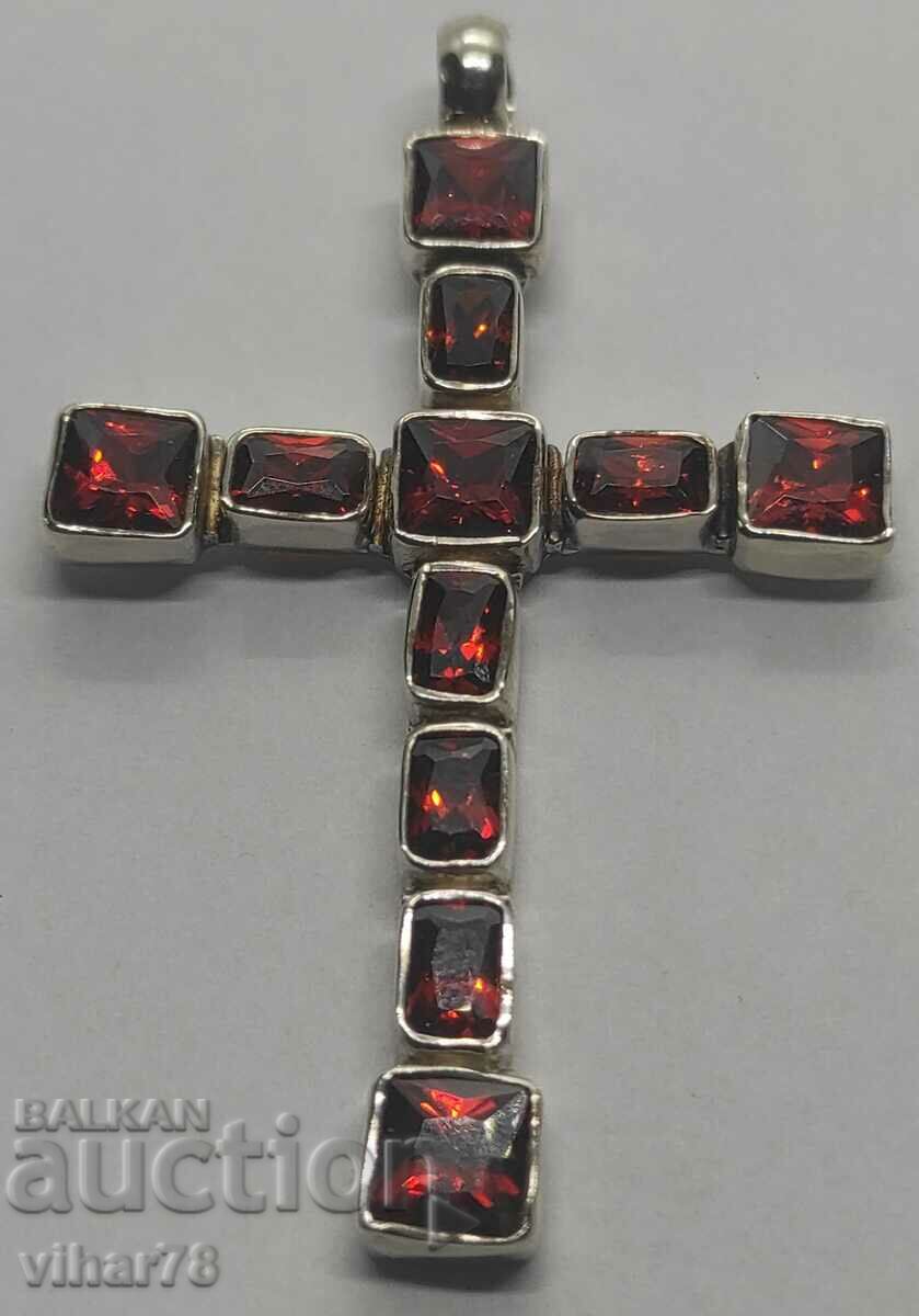 A large silver cross studded with garnets
