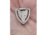 Old wolf head badge.