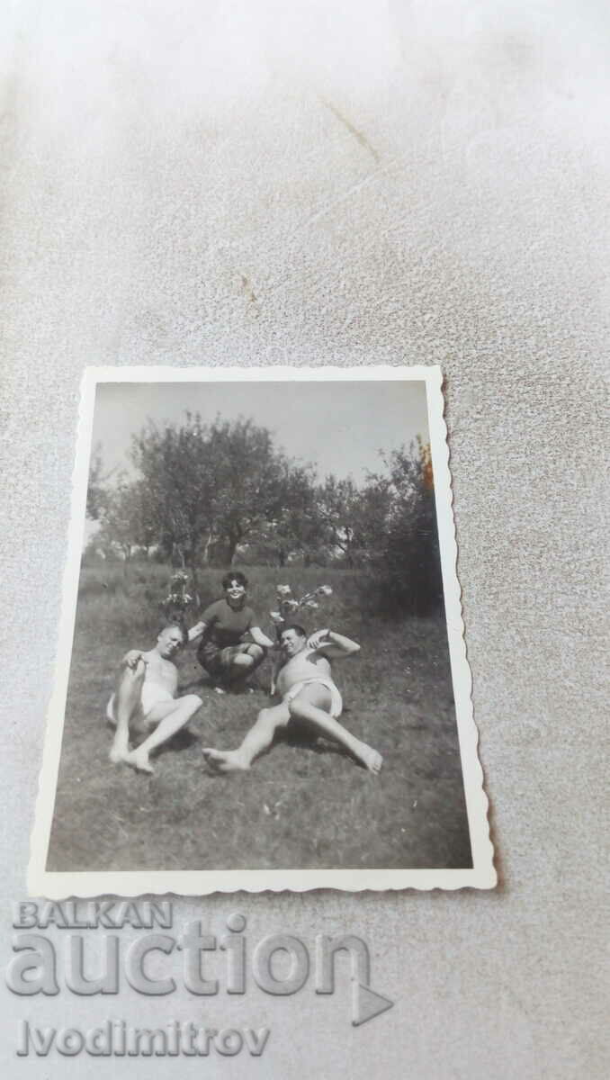 Photo Woman and two men in underpants on the meadow 1968