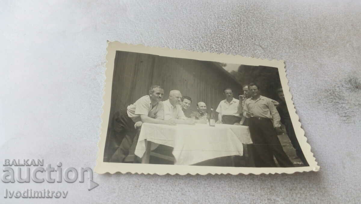 Photo Men at a table