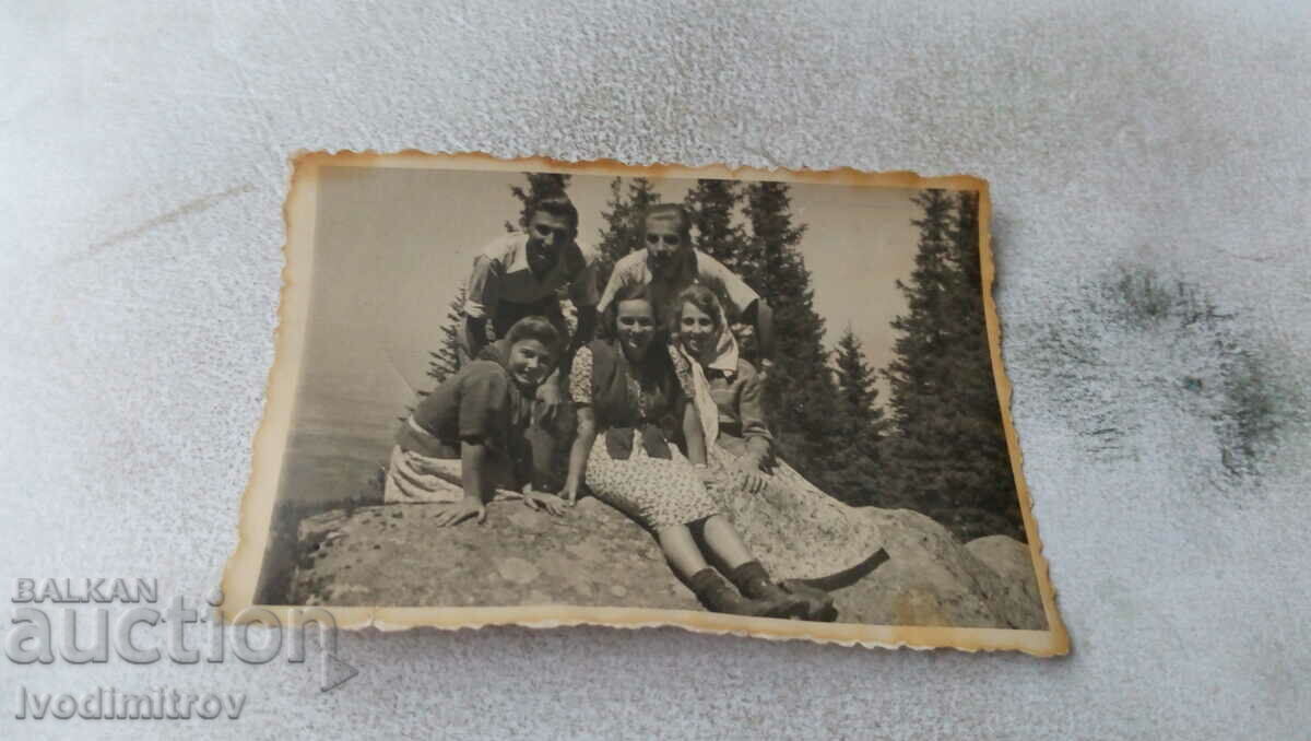 Picture Two young men and three girls on a rock