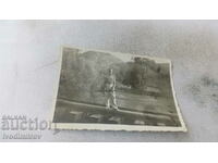 Photo Dolno village A young man with a shotgun. rails over a river