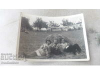 Photo Three men lying in a haystack