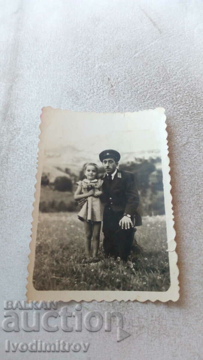 Photo Railwayman and a little girl on a meadow