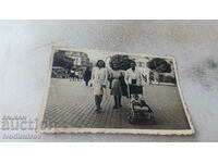 Photo Sofia Three women and a baby in a retro baby carriage