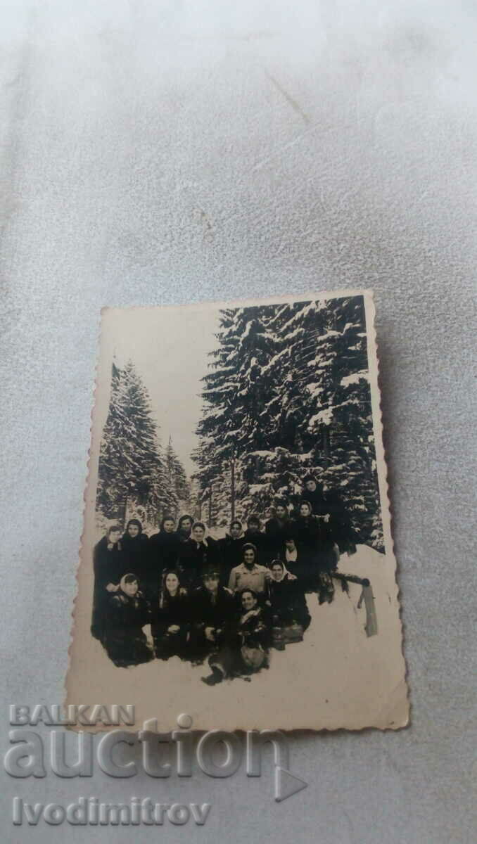 Photo Schoolgirls and teachers on a wooden bridge in winter