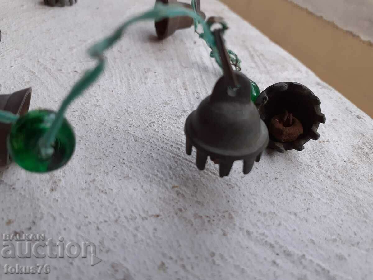 Delivery of Old ornament with bronze bells and green glass tied with wire