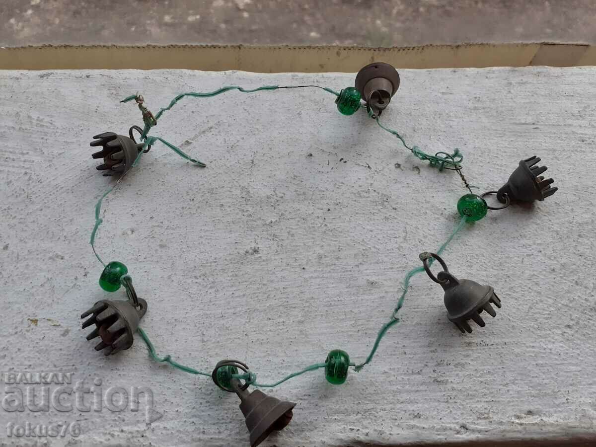 Old ornament with bronze bells and green glass tied with wire