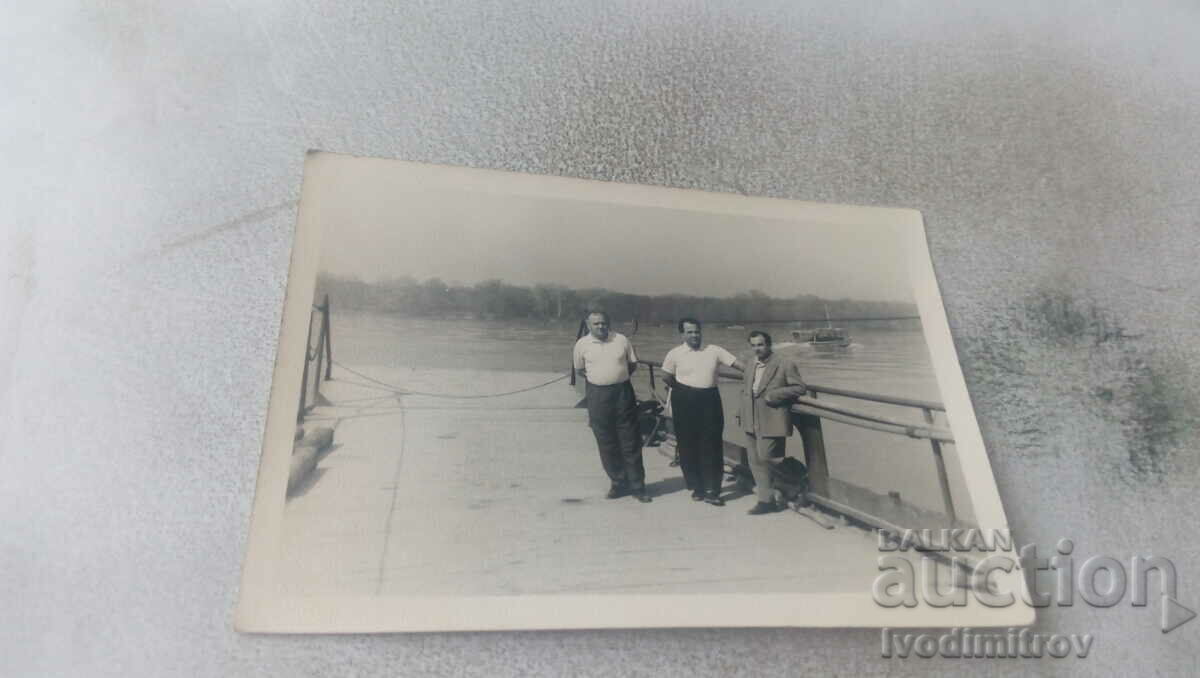 Photo Three men on the pier
