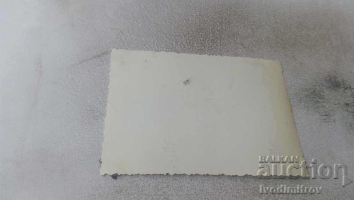 Photo Three men and a woman in front of a mountain hut in winter with price 0.75 BGN | € 0.38