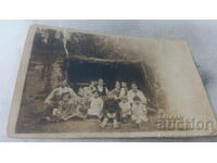 Photo Iskrets Man women and children in front of a wooden shed