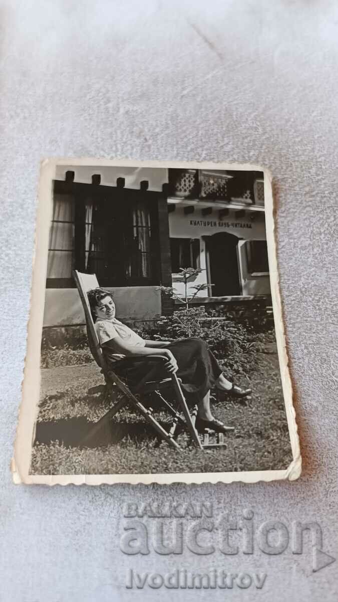 Ms. Borovets Woman in a lounge chair in front of the Culture Club-reading room 1957
