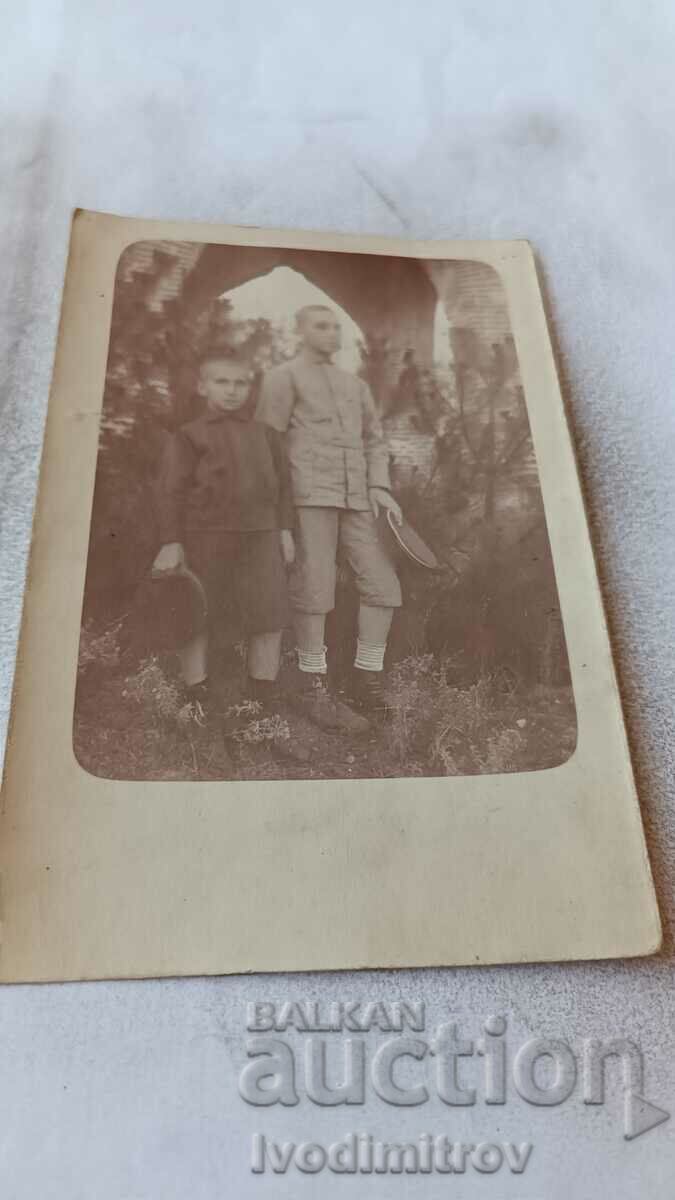 Picture Two boys with hats in their hands