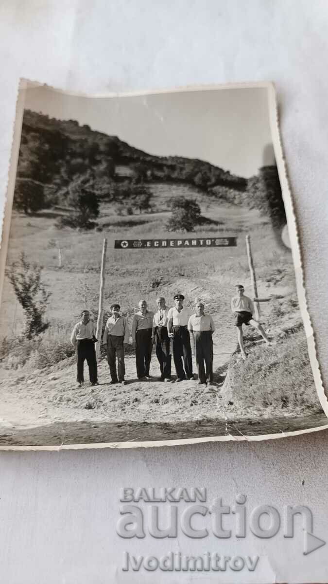 Photo Men and a boy in front of the sign ESPERANTO in the mountains