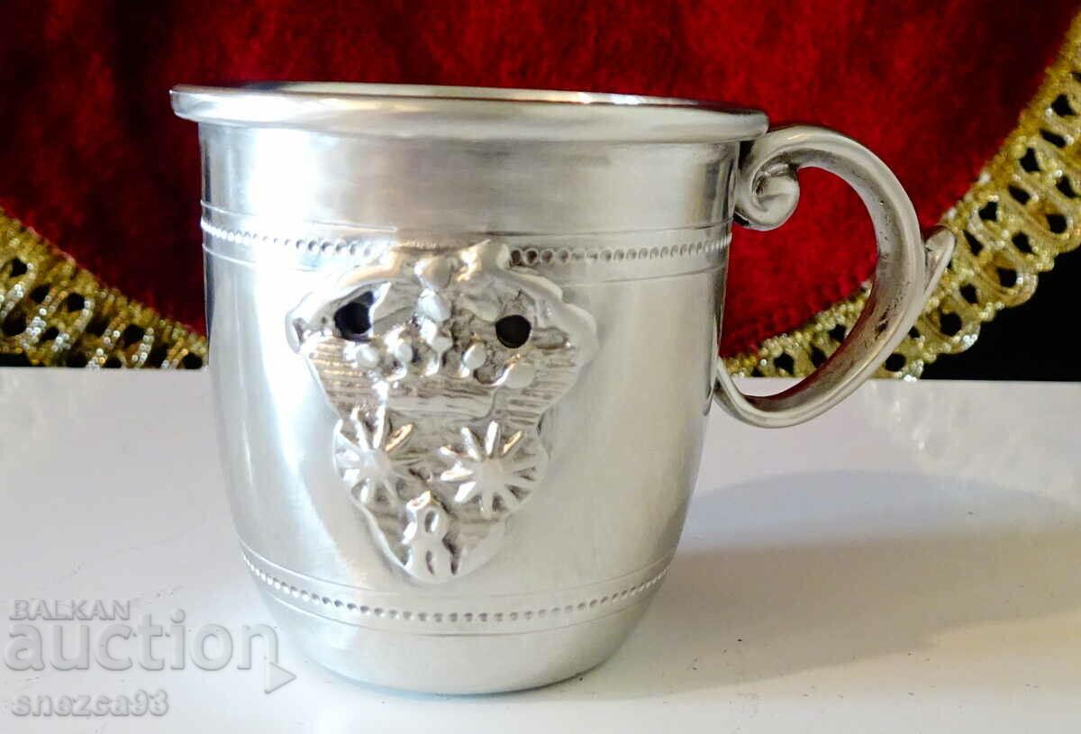 Pewter cup with crown, royal coat of arms.