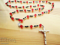 Hematite rosary type necklace with red elements and a cross