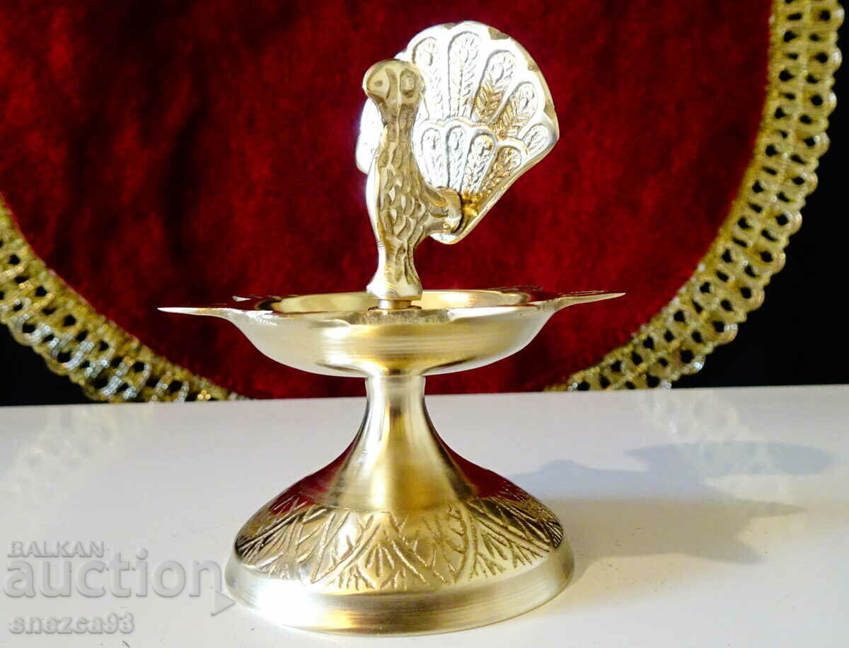 Auction  Bronze candlestick with Peacock.