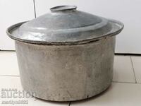 An old bakery saucepan, a baker, a brass copper pot