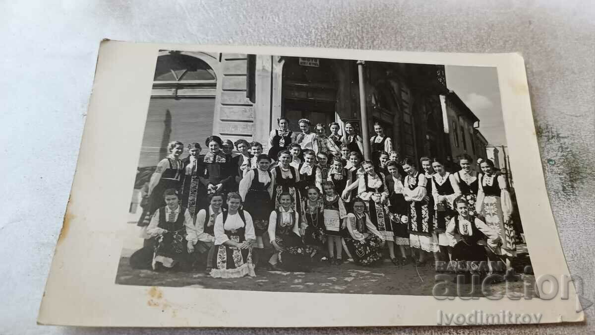 Ms. Young girls in folk costumes in front of Photo Tseko G. Petrova