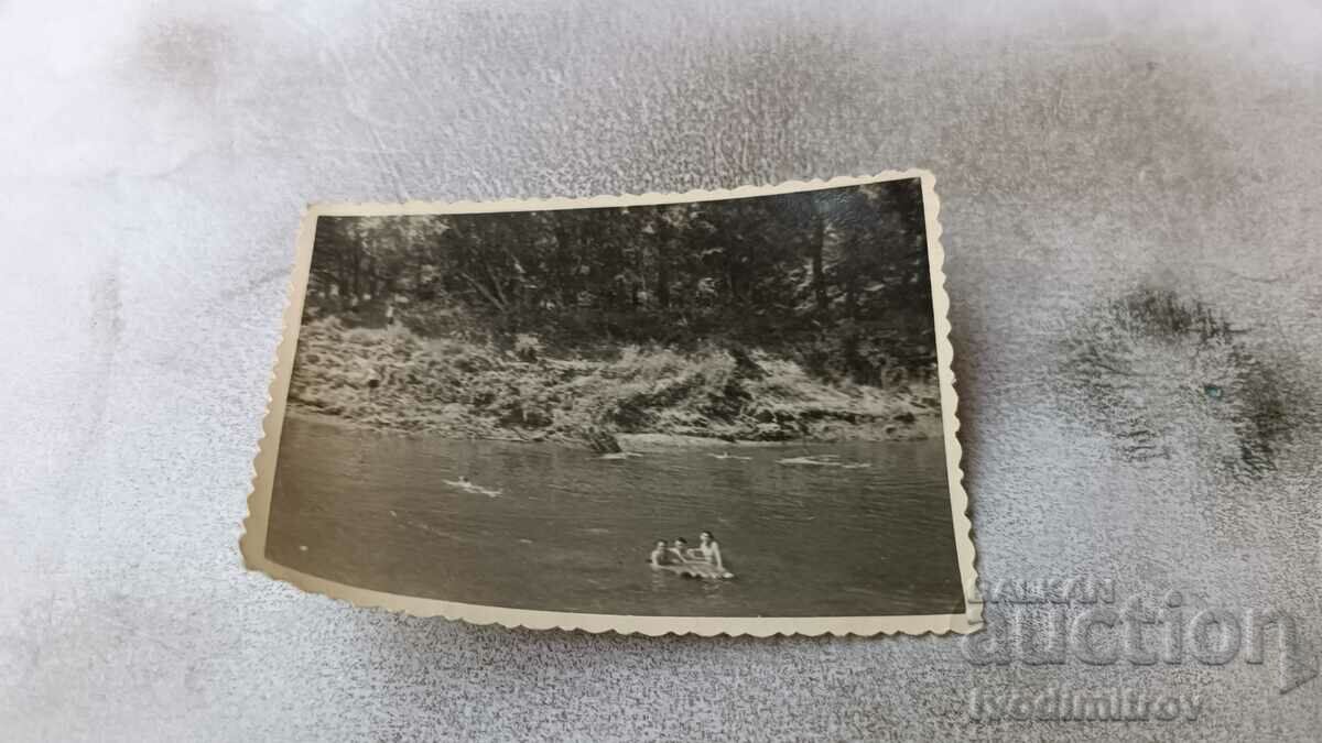 Photo Three men in the river