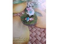 Porcelain figures on a wooden stand.