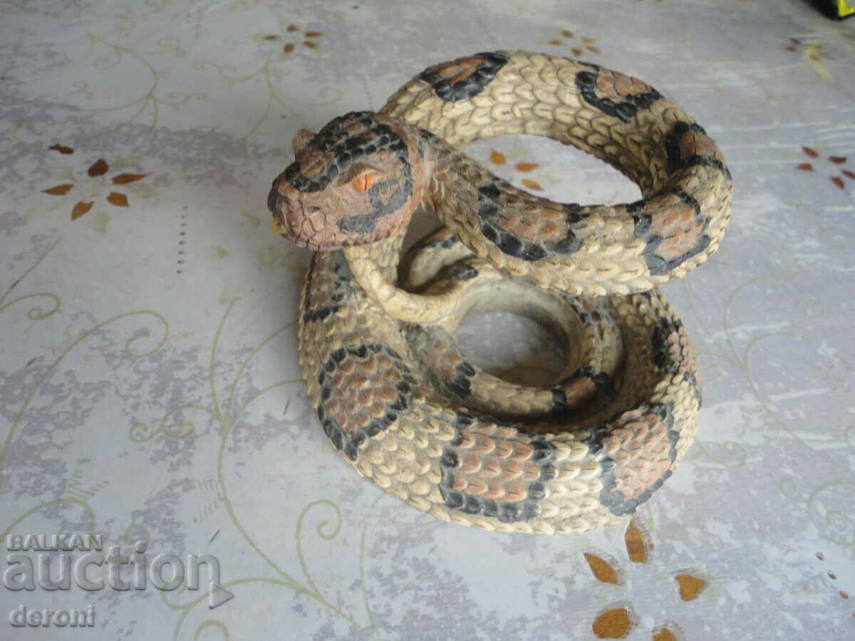 Auction A sculpture of a rattlesnake figure Auction A sculpture of a rattlesnake figure